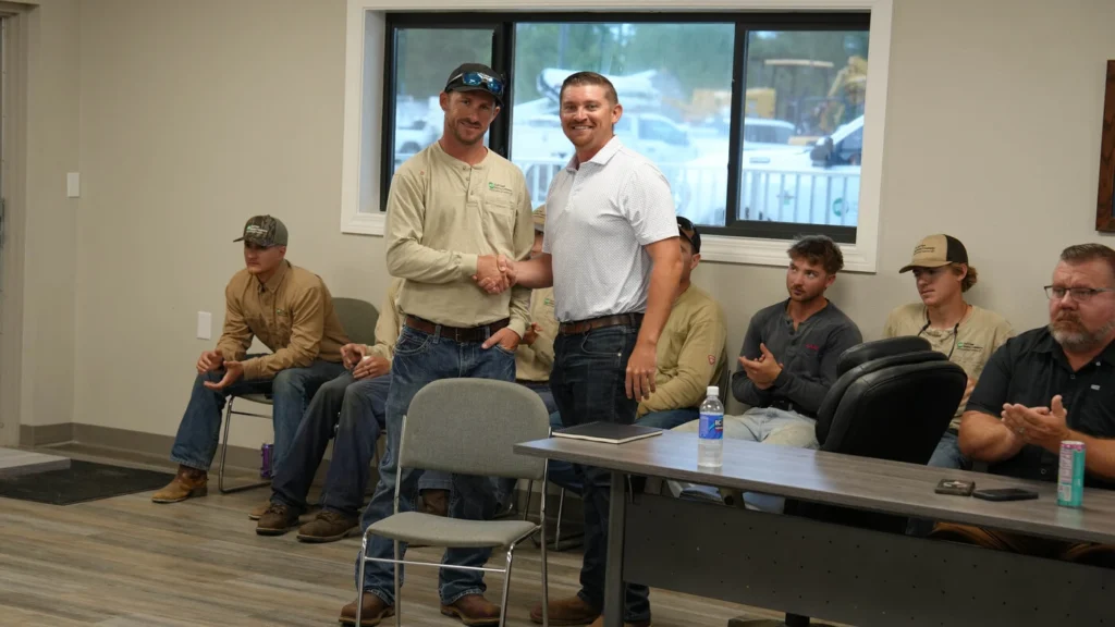 Cole, right, congratulates Baylen Price on his recent promotion.